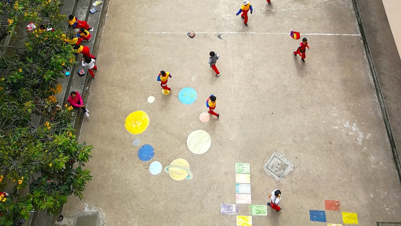Aerial image of a schoolyard with children playing.
