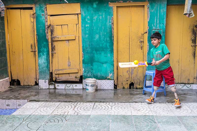 Fayaz, hits a shot with his cricket bat.