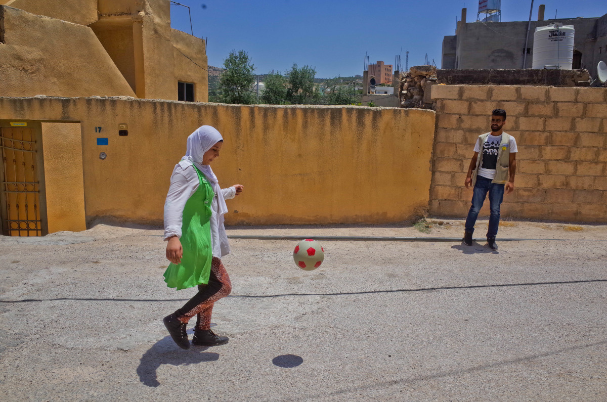 Salam practices her football skills.