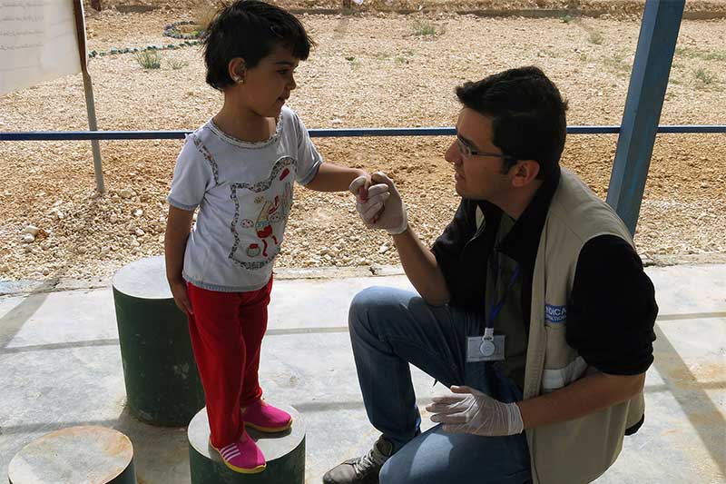 Malak having a rehabilitation session with a Handicap International physiotherapist, in Jordan.