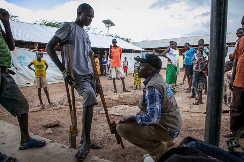 Handicap International rehabilitation team leader speaks with Simon at Kakuma camp reception centre