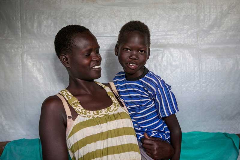 Omot with her mother at the Kakuma reception centre