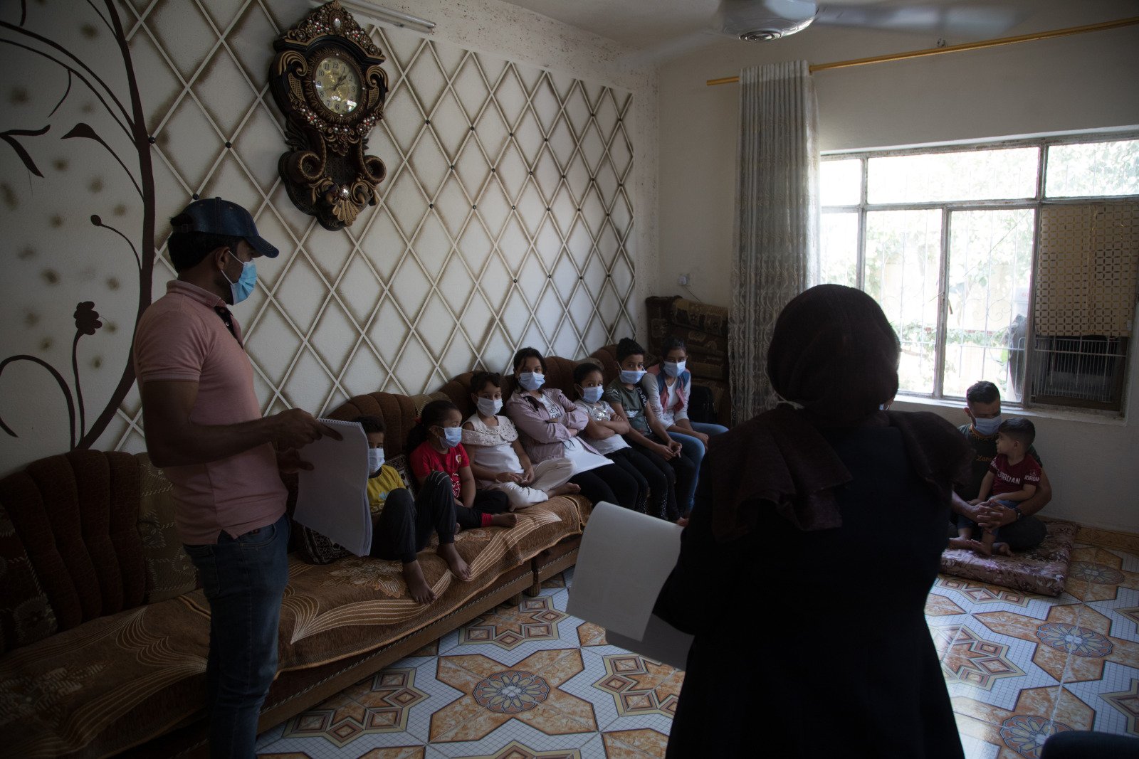 Volunteers working with Humanity & Inclusion raising awareness about the risks associated with landmines and explosive remnants of war.