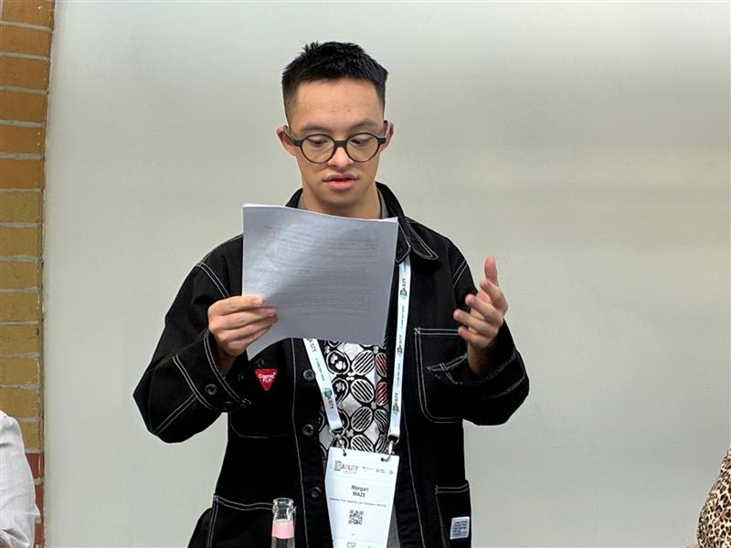 Morgan Maze, DSi Ambassador and self-advocate from Indonesia, presenting preliminary results of the report at the Global Disability Summit, in Berlin, April 2025. © Down Syndrome International