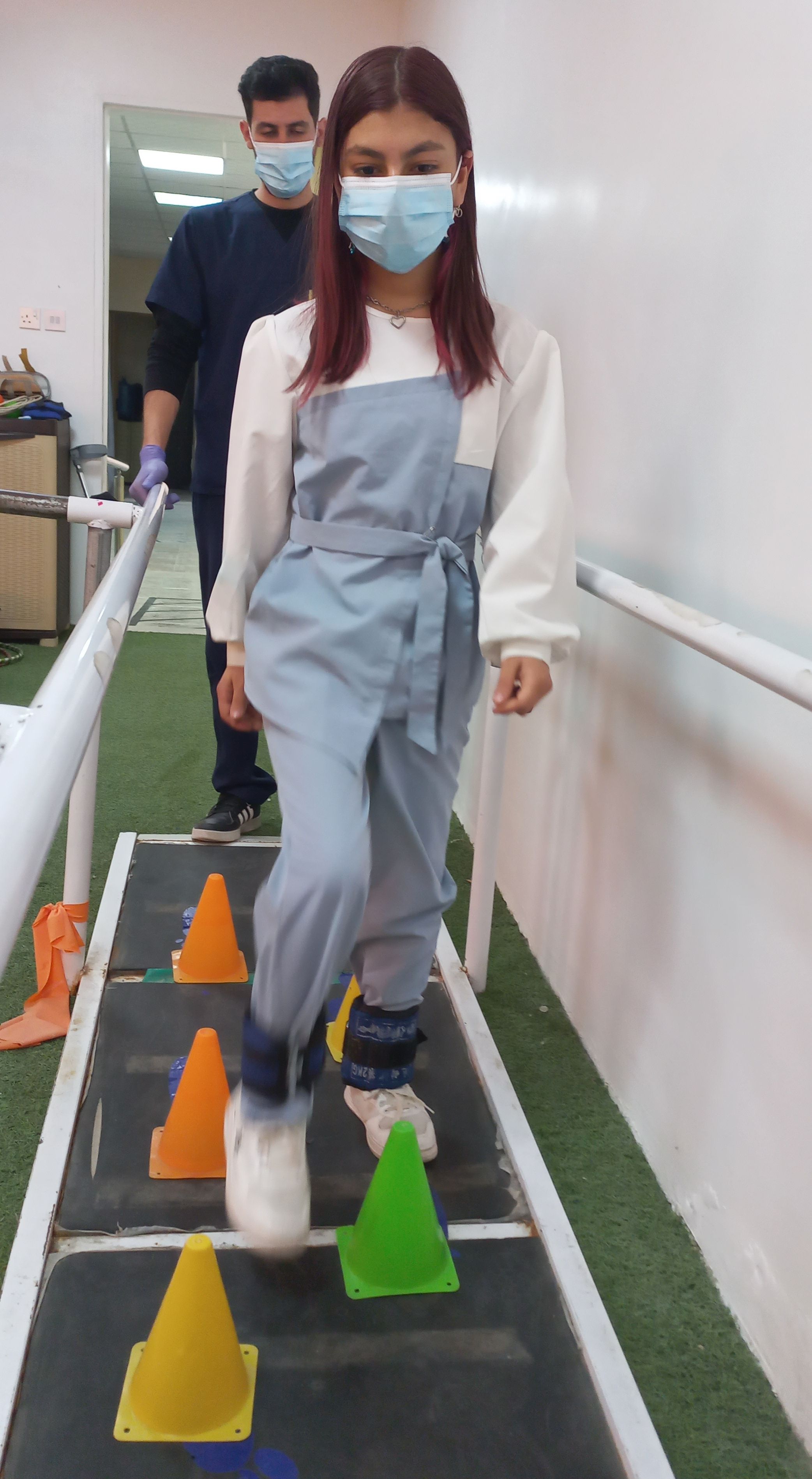 Gina during a rehabilitation session, performing an obstacle course exercise.