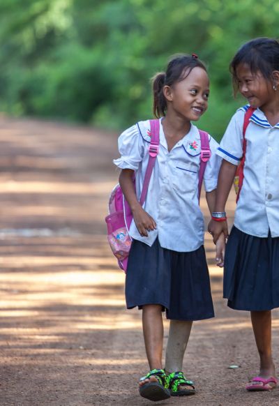 Channa, 7 years old, with a classmate on the way to school Channa, 7 years old, with a classmate on the way to school
