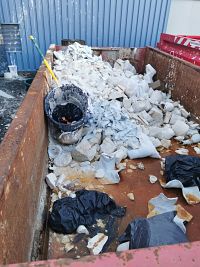 ©A.BANOUNE/HI. Plaster waste sits in the dumpster after use.