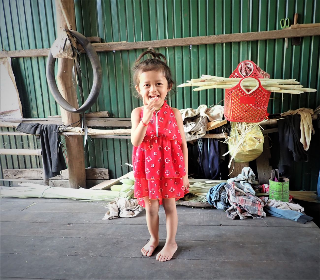 Caption: Thanks to early screening by HI, Un Sonita’s, striking a pose with her red dress, clubfoot was diagnosed very early on. 