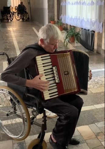 Taras plays his newly donated accordion. 