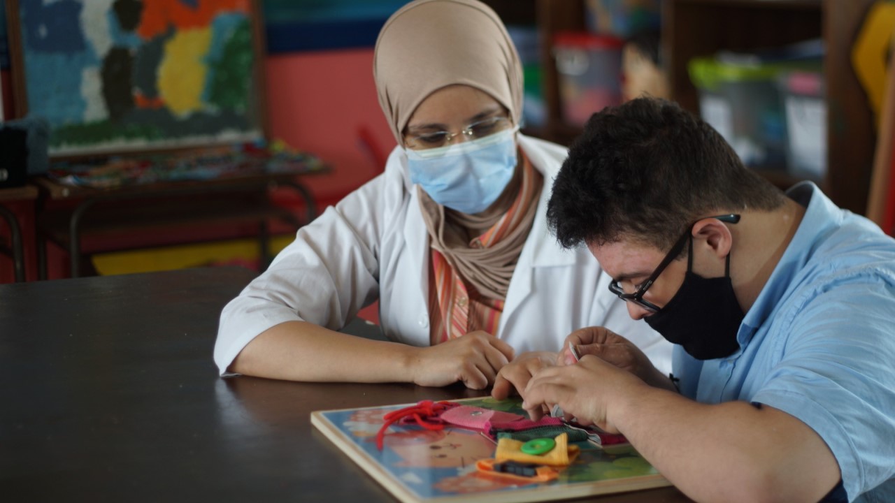 A child and an occupational therapist play together.