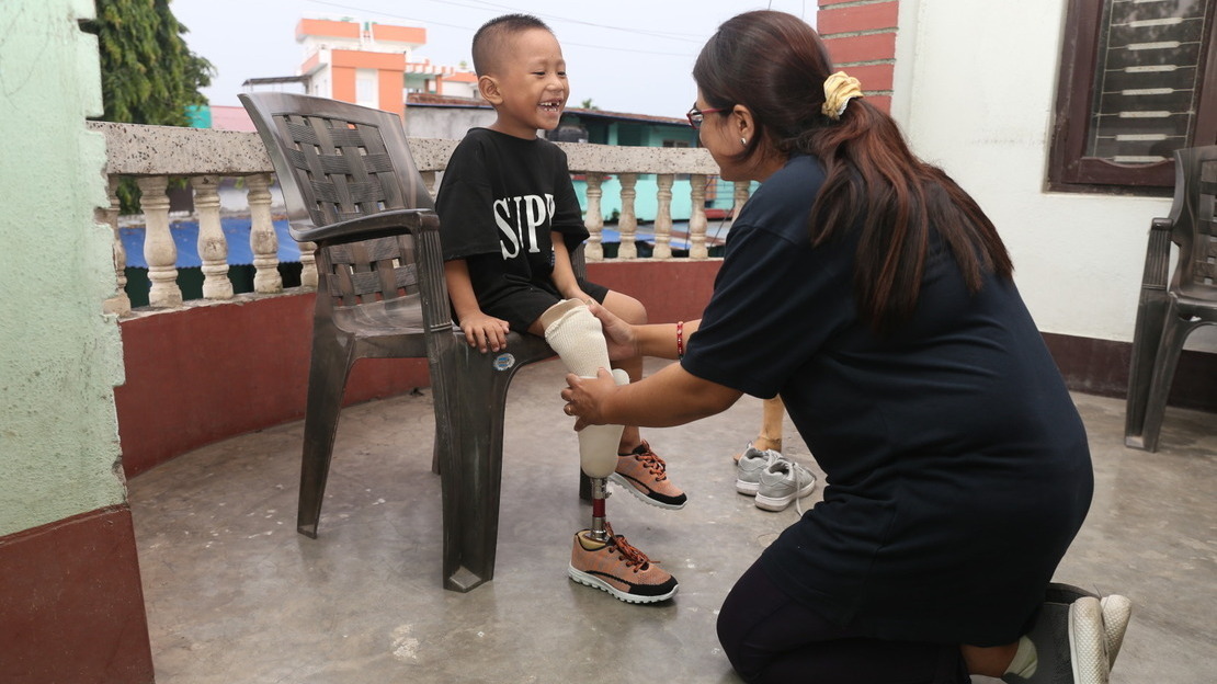 Ambika, Prosthetist and Orthotist is fitting Prabin, with a new prosthesis.