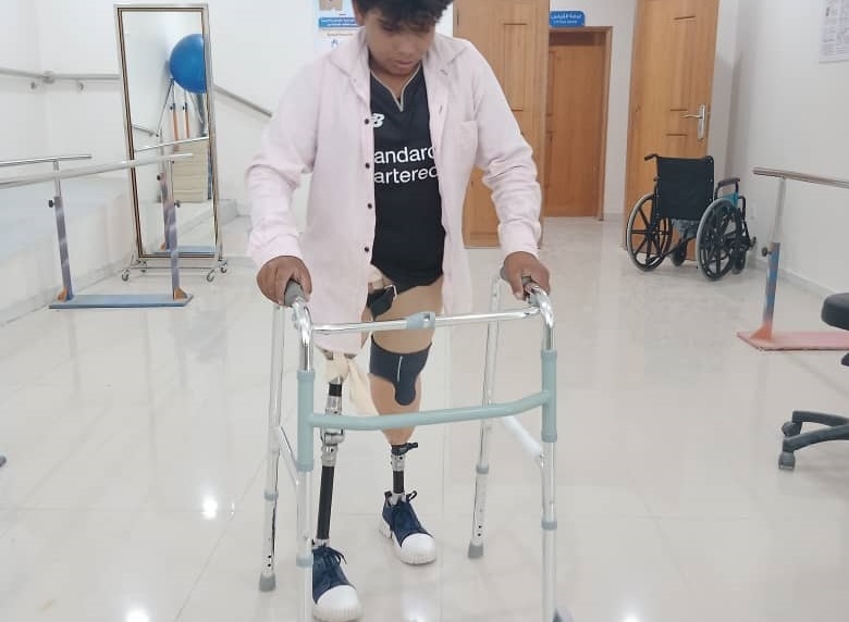 Hussein practicing walking with two prostheses 