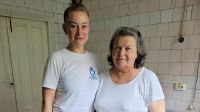 Physical therapist Anastasia (left) stands with Nadezhda (right).  