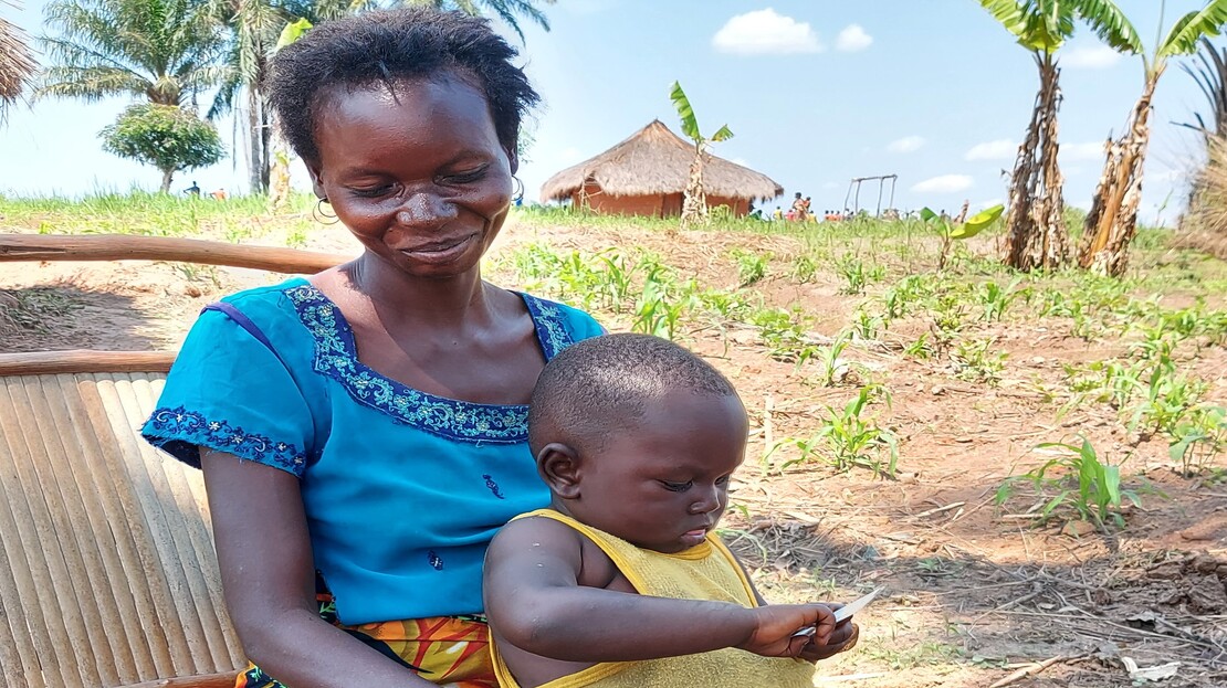 Marie holding her 3-year-old son Kasonga