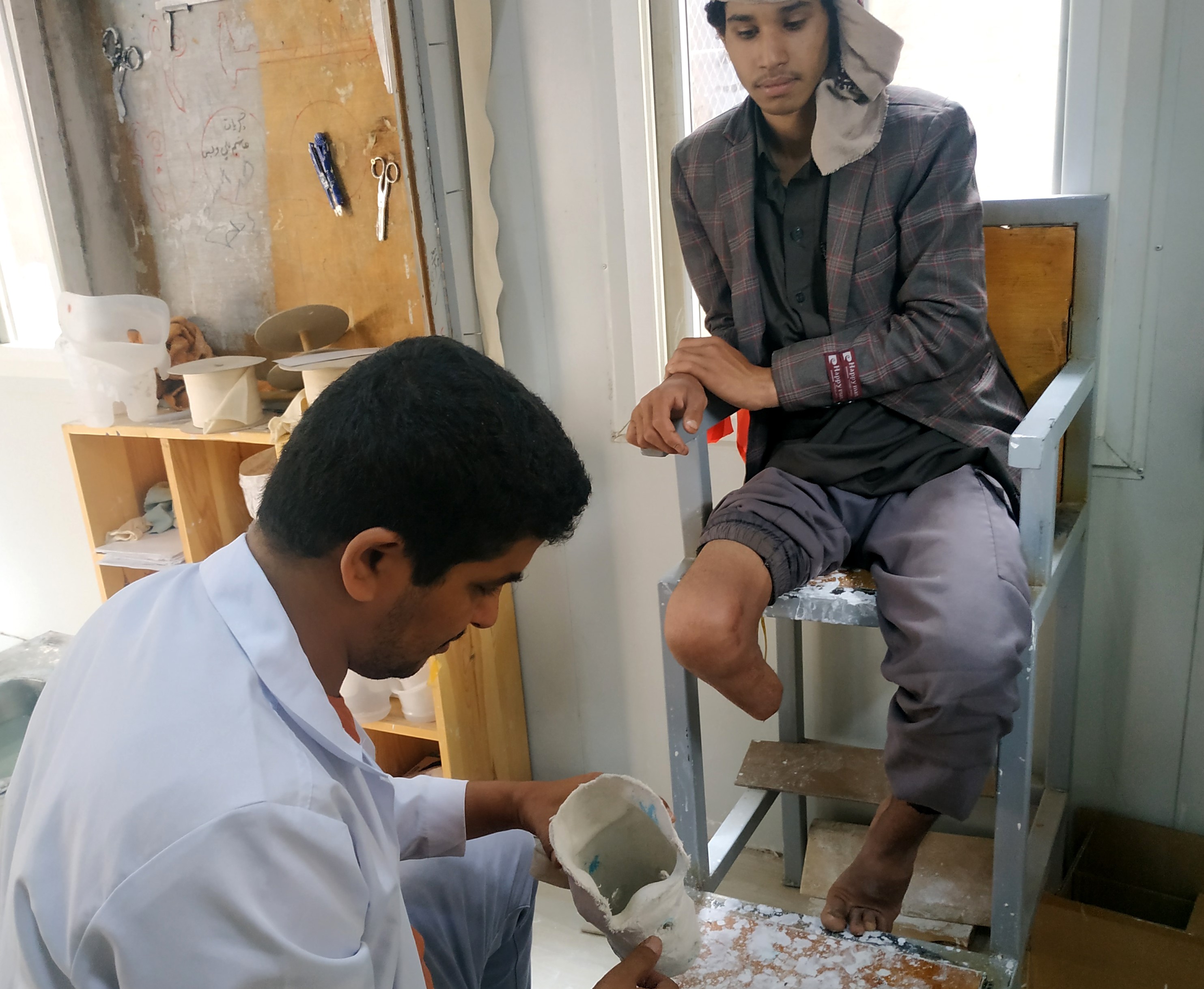 Abdel with an HI physiotherapist for the follow-up of his prosthesis