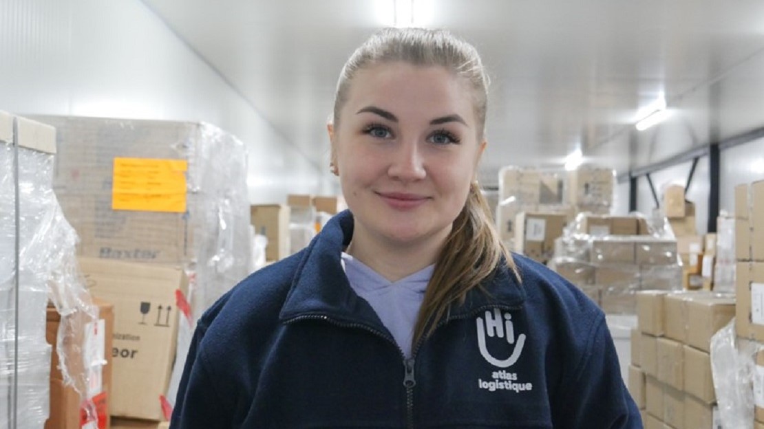 Young women in HI warehouse wearing an HI sweater