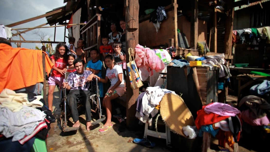 Kids and disabled teenager in front of a house