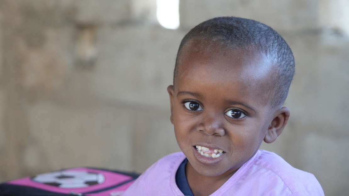 Portrait of Mahamadou, looking and smiling at the camera.