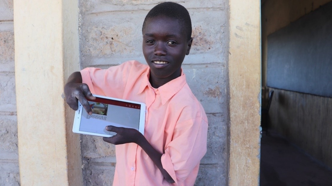 Patrick shows the story he just read in a digital class.