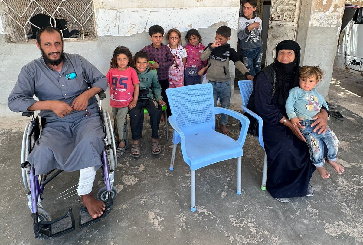 Abdul at his home with relatives
