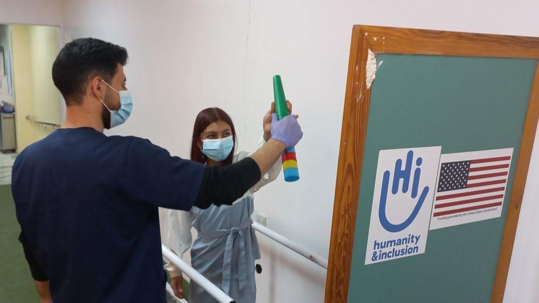 Caption: Gina during a rehabilitation session at the community development centre in Zarka, Jordan, with her physiotherapist