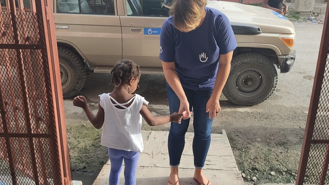 HI staff with a child being supported  at the rehabilitation centre in Les Cayes, Haiti after the earthquake. 2021