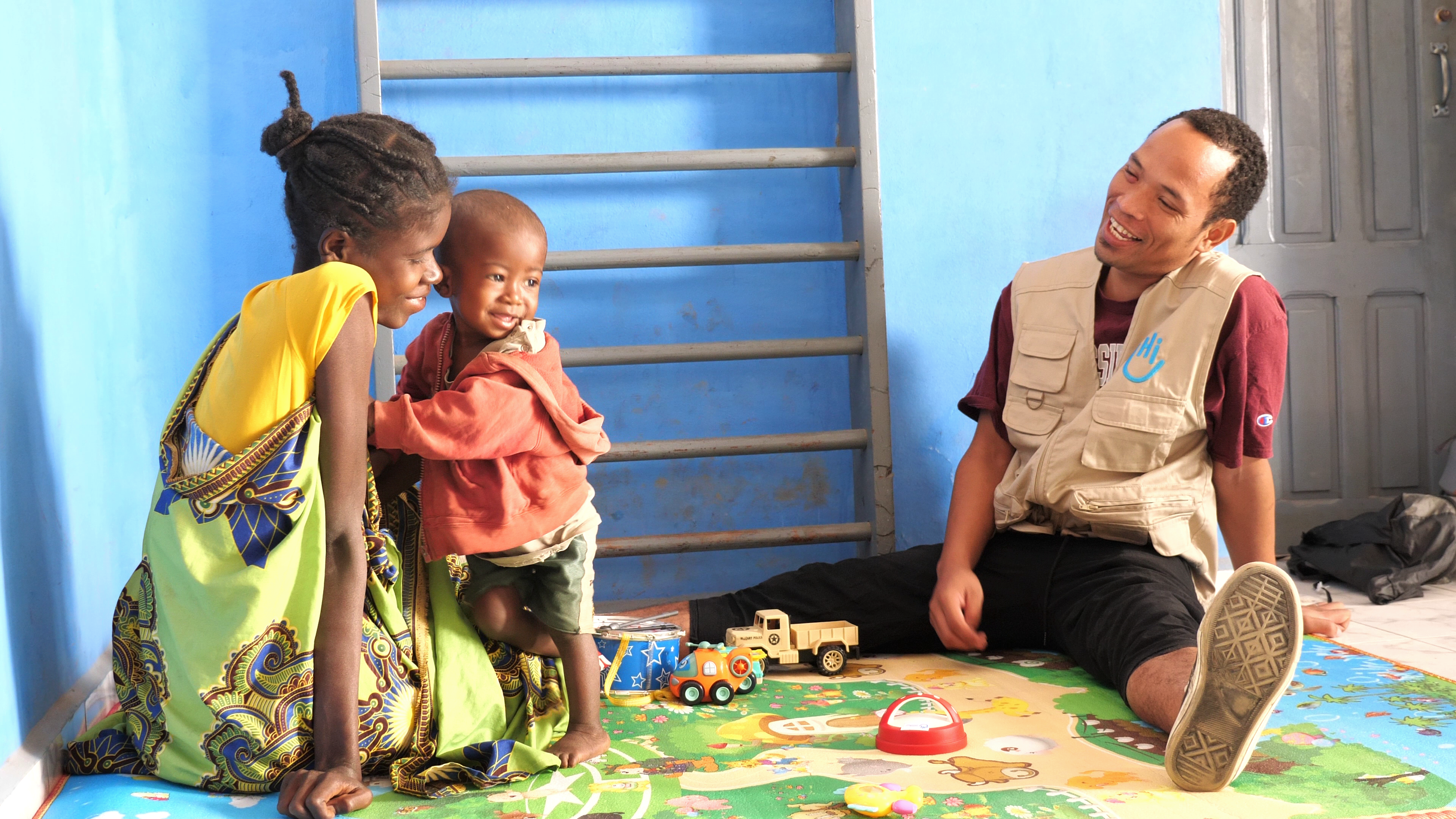 Nasolo and his mother Odile in a stimulation therapy session with physical therapist Jean Noel in Tuléar Madagascar. 