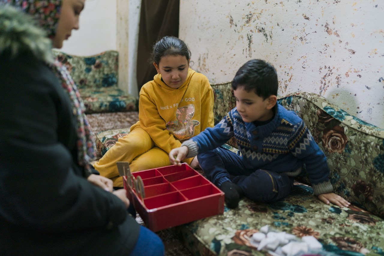 Sheima and Khaled are very close. The 13-year-old helps her little brother with his exercises.