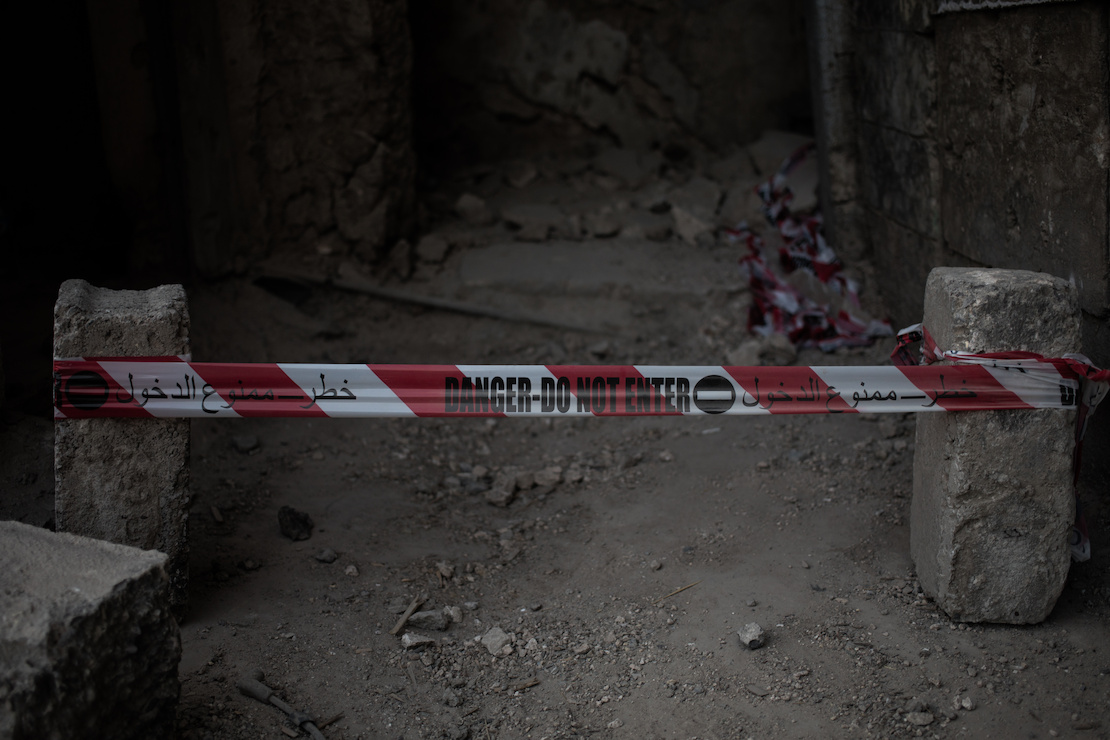 A bombed building with a danger sign, Mosul, Iraq