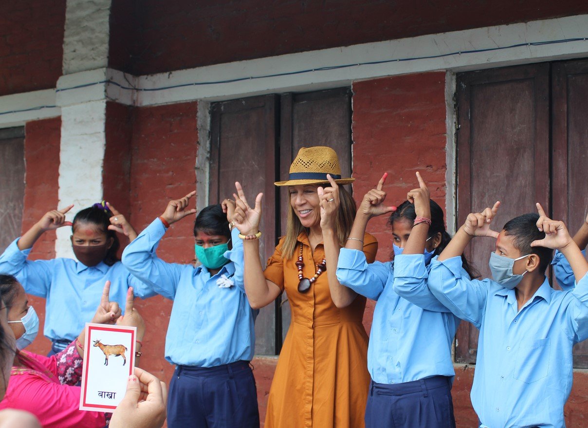 Girls with hearing impairment teach Helen Grant MP how to sign the word ‘goat’ in Nepali Sign Language.