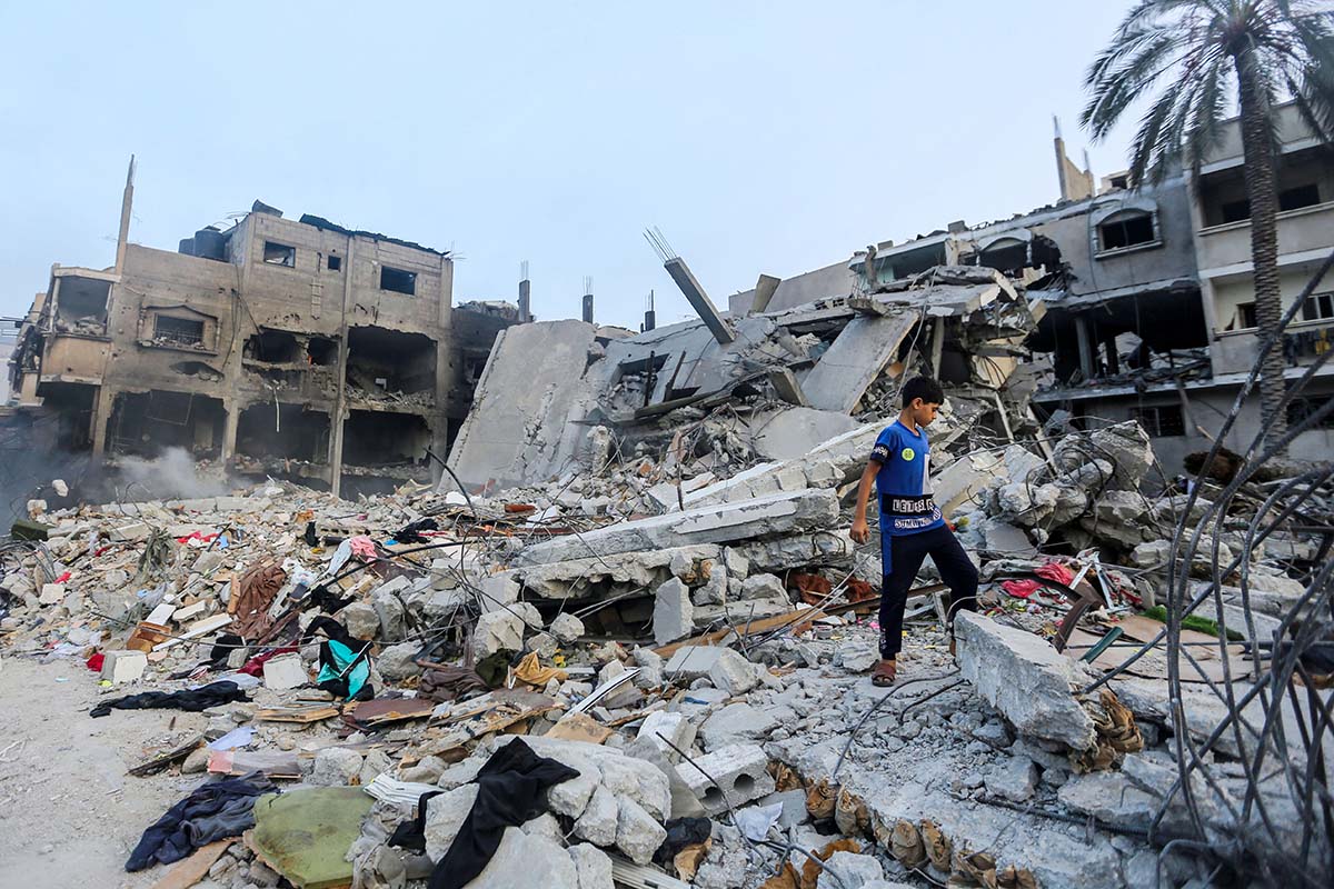 Children search through buildings, destroyed during Israeli air raids in the southern Gaza Strip on November 8, 2023 in Khan Yunis, Gaza. 