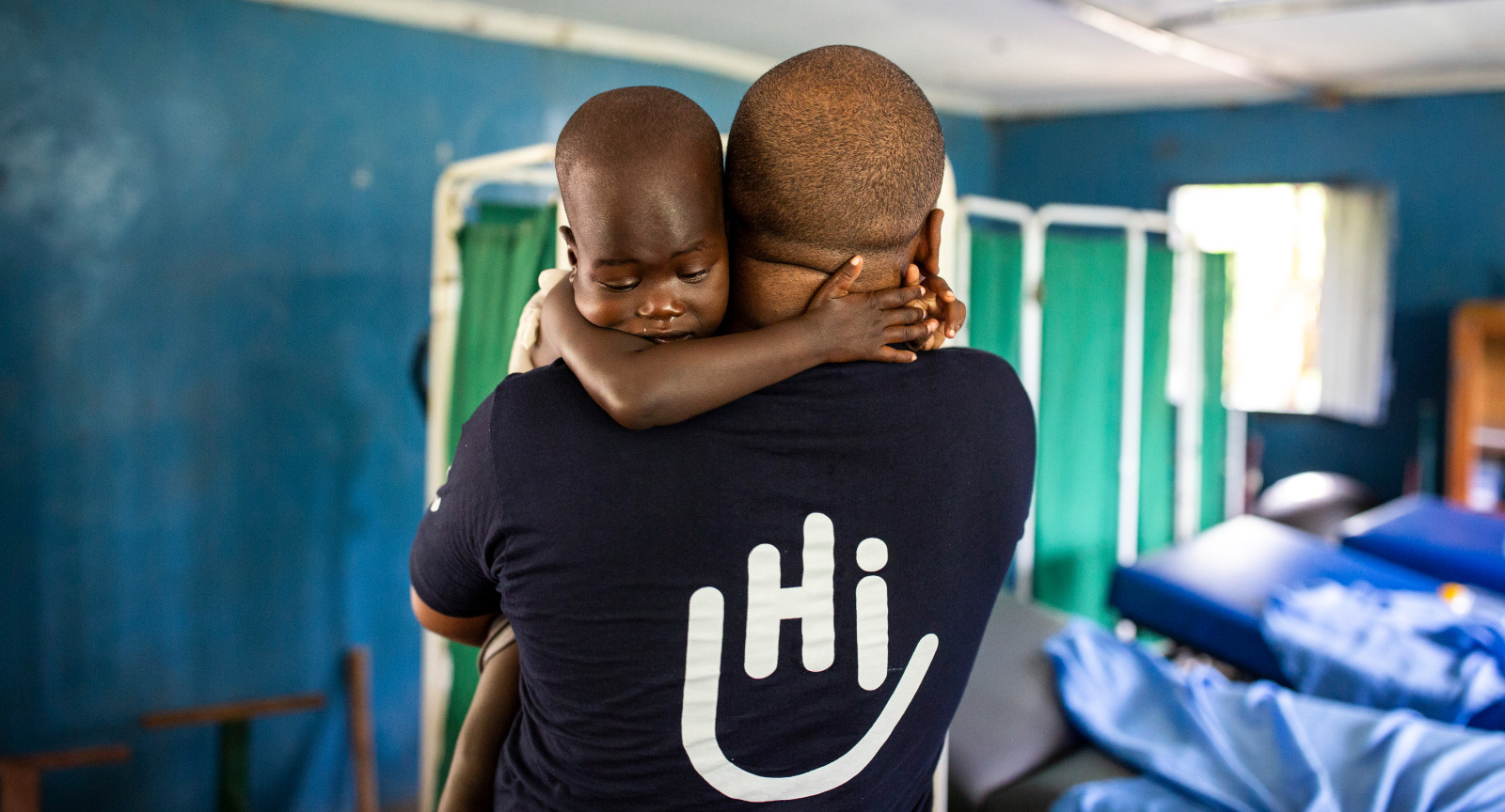 Simon Njenga, an HI occupational therapist, during a rehabilitation session with Elizabeth at Rehabilitation Center 1 in Kakuma, Kenya.