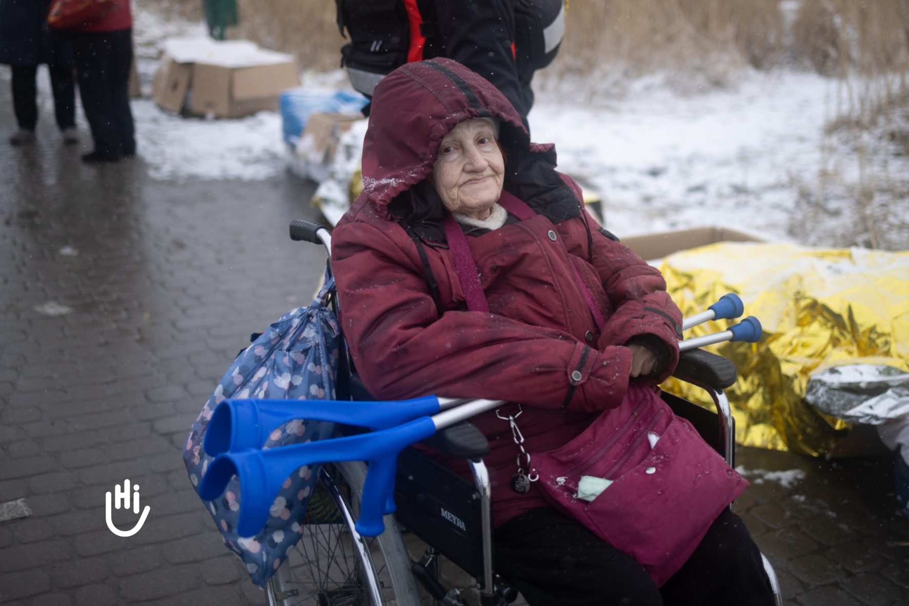 Galaina, 87, crossing the border from Ukraine to Poland in her wheelchair at the Medyka crossing, 2022.