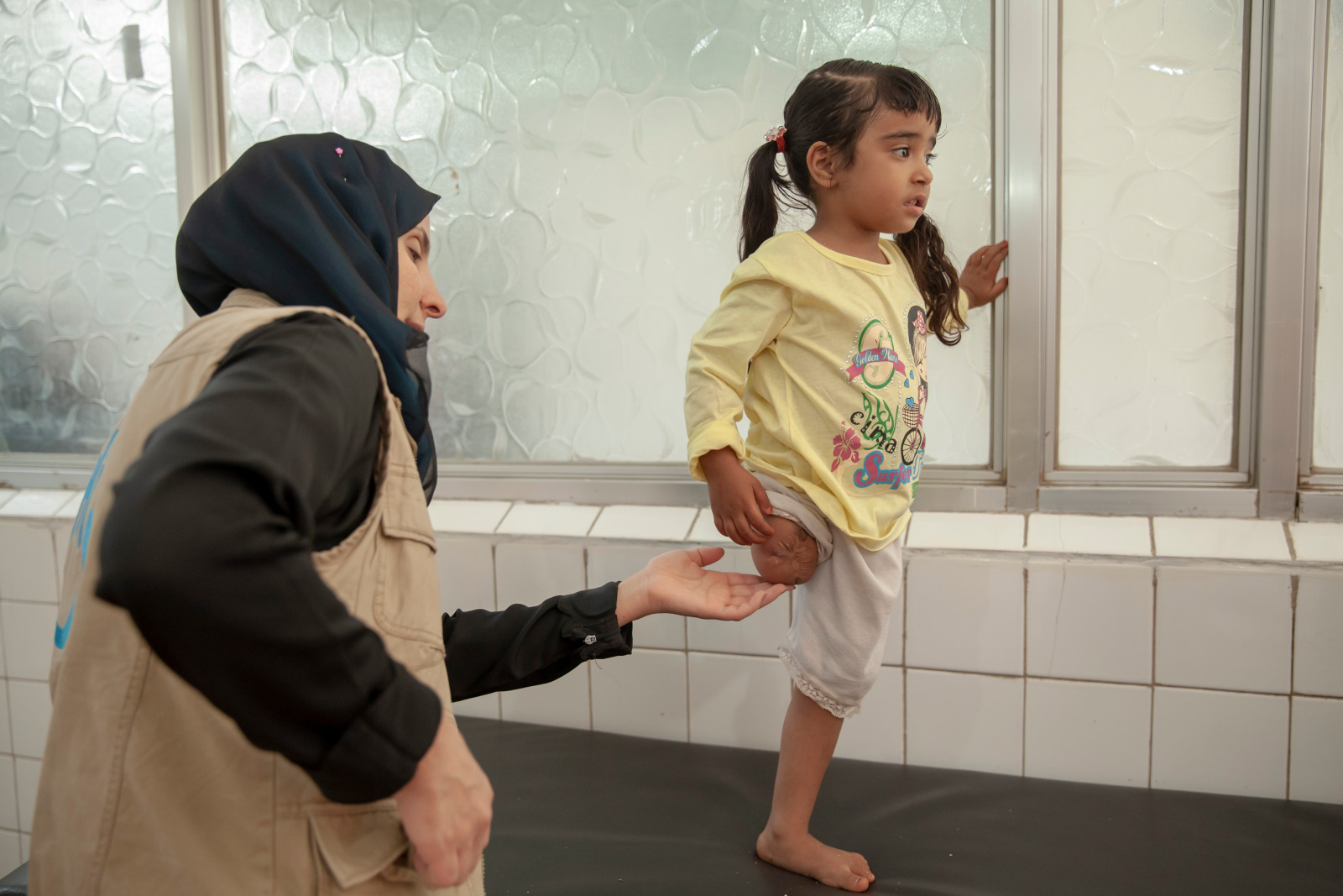 Hala standing on her one leg in a rehabilitation session
