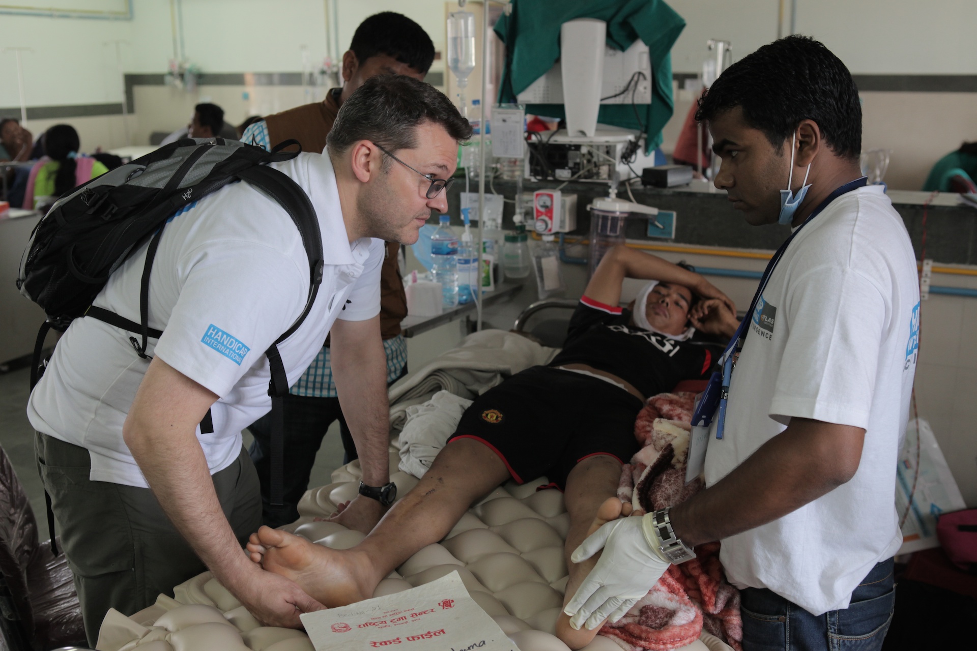HI physiotherapists attend to a victim of the Nepal earthquake with a spinal cord and a head injury.