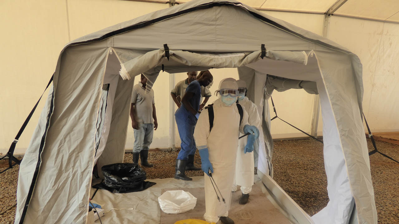 Ebola crisis. Teams testing an inflatable tent. Sierra Leone.; }}