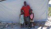 Jeanty Emile and his children lost their house after Matthew hurricane hit Haiti on 4th October 2016.; }}