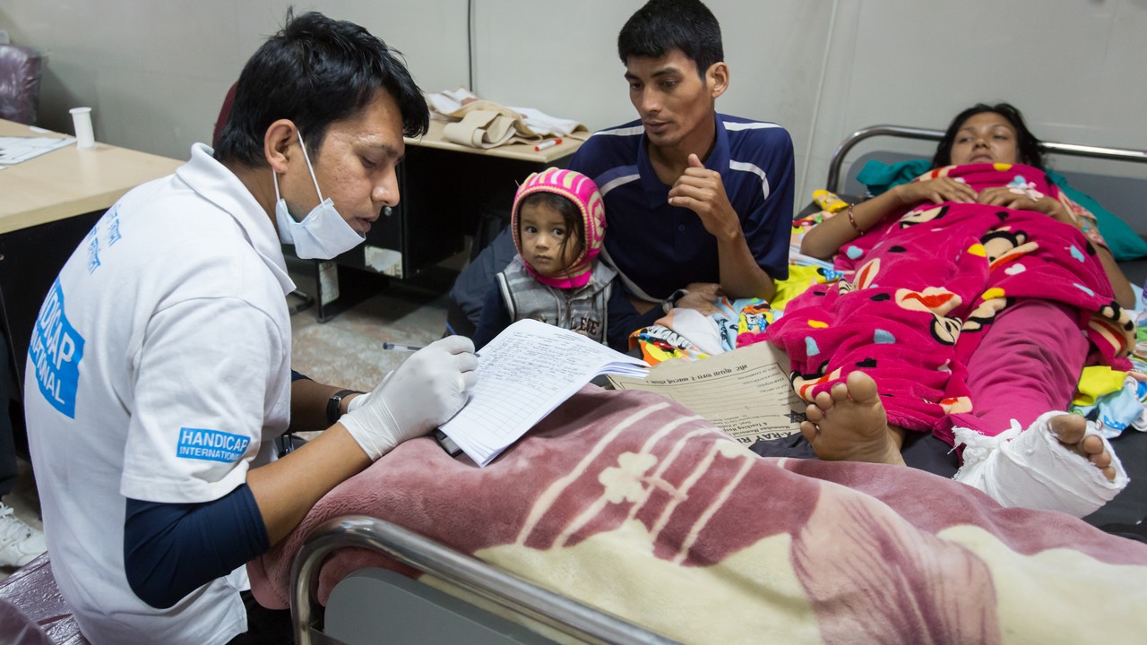 Occupational therapist, Pushpak, assesses the needs of an injured earthquake victim. Nepal.; }}