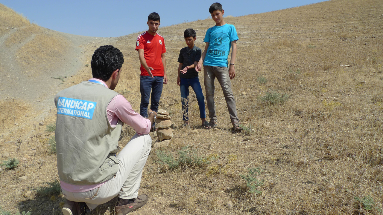 These children found an unexploded device while playing and used the techniques they had learned in the risk education sessions to secure the area while awaiting the demining team.; }}