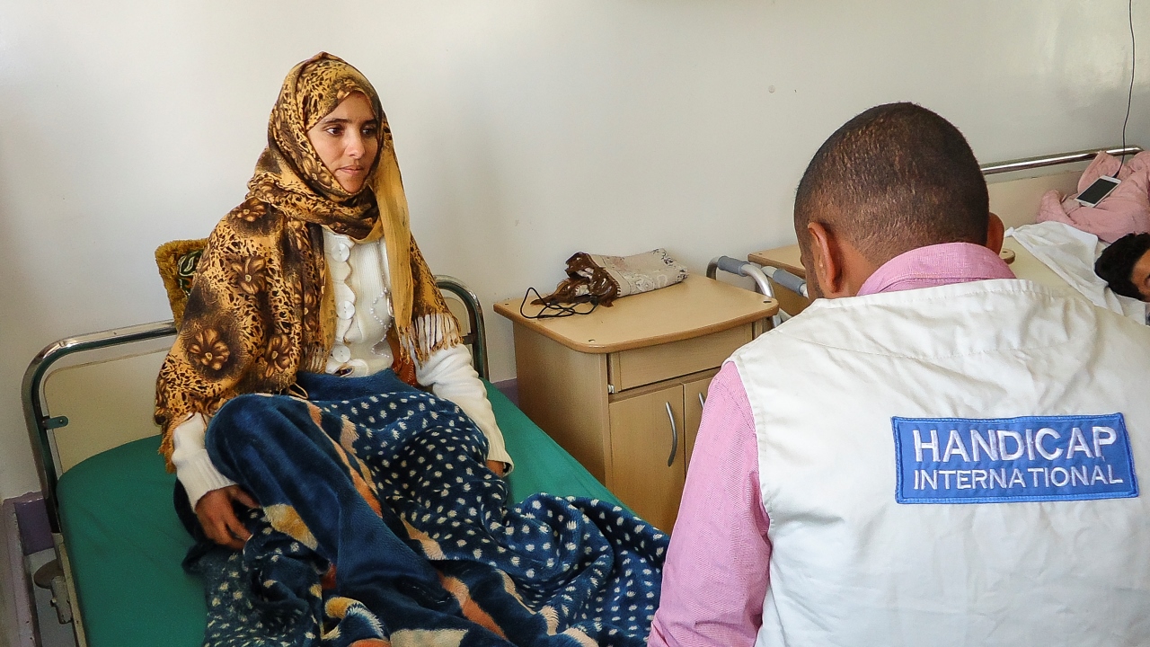Injured in an air strike, Bushra, 24, receives treatment from Handicap International’s team in Al Thawra hospital, Sana’a.; }}