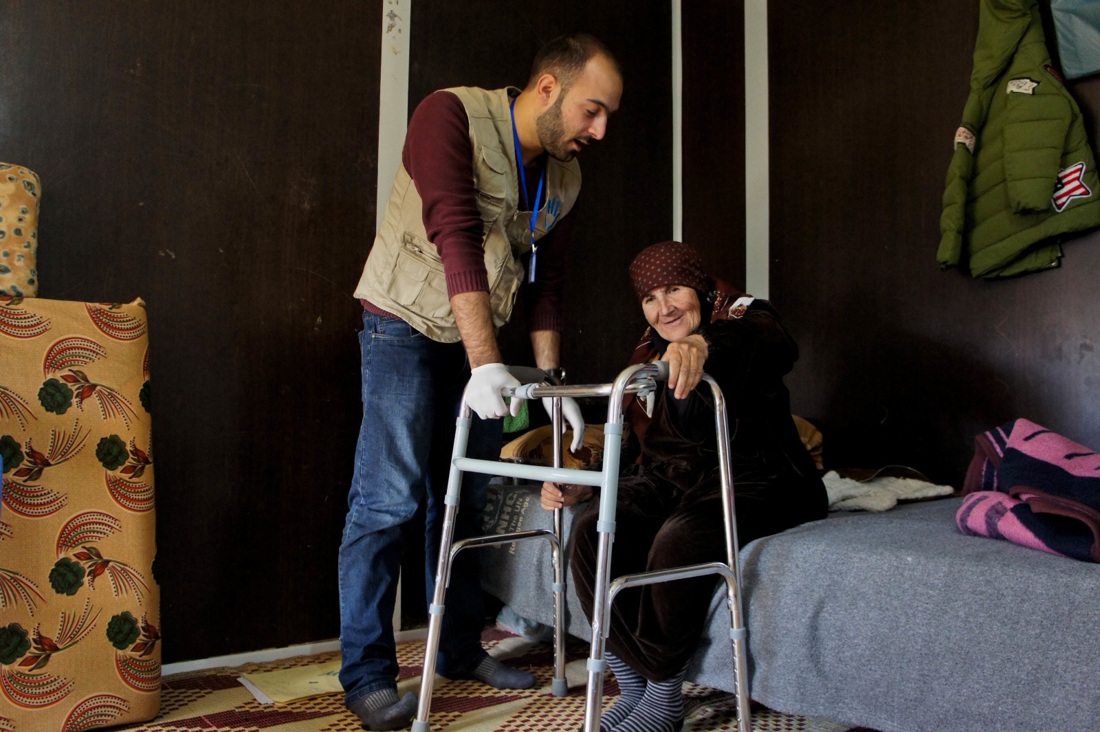 HI Physiotherapist Mo'men does a rehab session with Nawal, a 70-year- old Syrian woman with a hip fracture.; }}