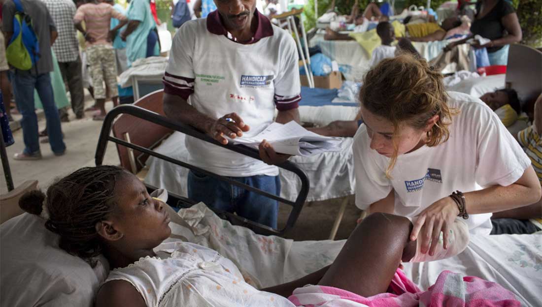 An HI physiotherapist provides emergency rehabilitation treatment to a victim of the earthquake in 2010; }}
