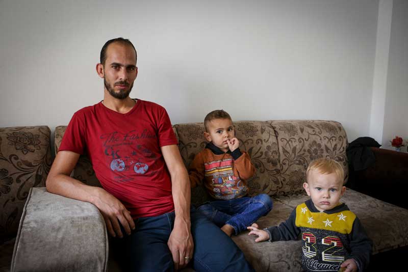 Ibrahim sitting with his two children