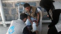 Salim being fitted with a prosthesis by an HI physiotherapist; }}