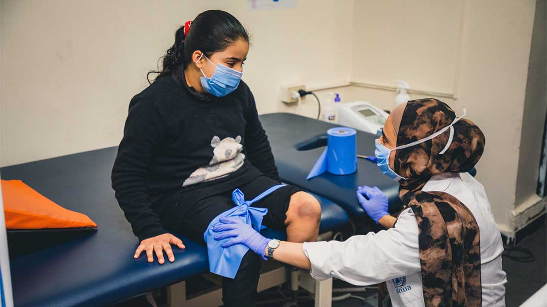 Salam being fitted for a prosthetic leg, Jordan; }}