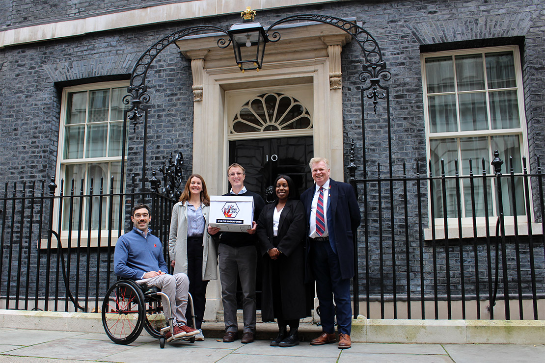 Trustees and staff from Humanity & Inclusion UK (Ollie Thorn, Chloe Marshall, George Graham, Karen Koromah, and Peter Burdin) hand in the Stop Bombing Civilians petition at 10 Downing Street | © T. Shelton / HI