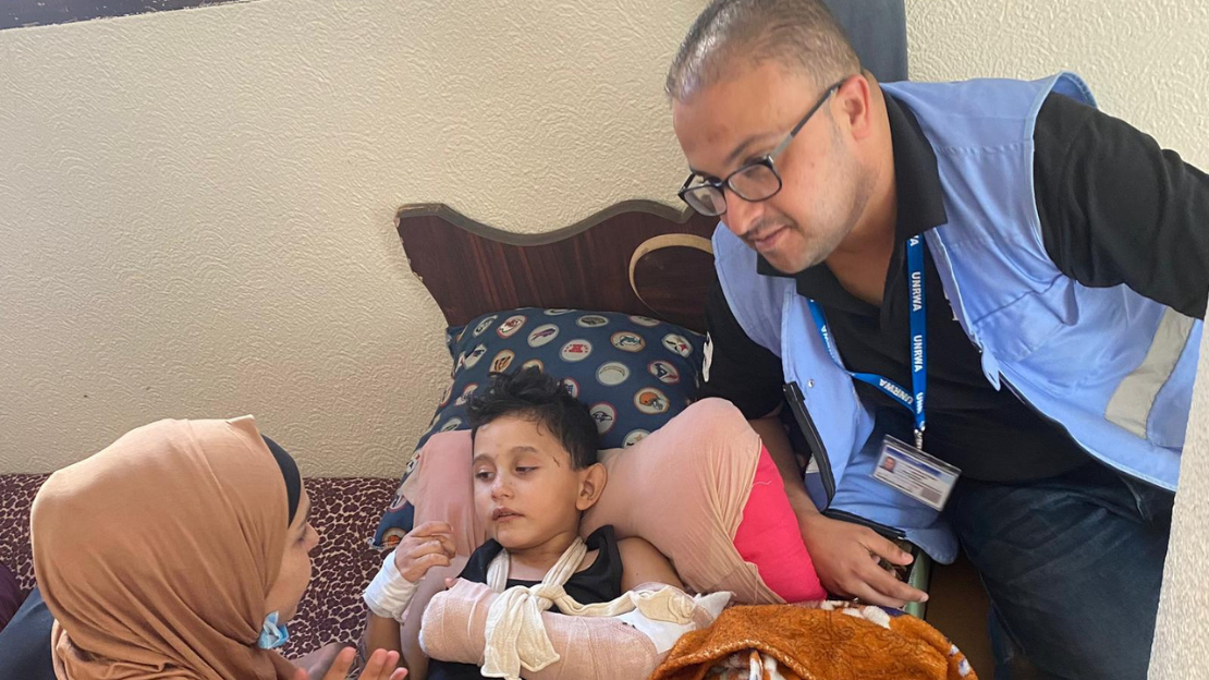HI Staff and volunteers assessing needs and providing assistive devices and kits for IDPs' in emergency shelters, Rafah, Gaza, last October ; }}