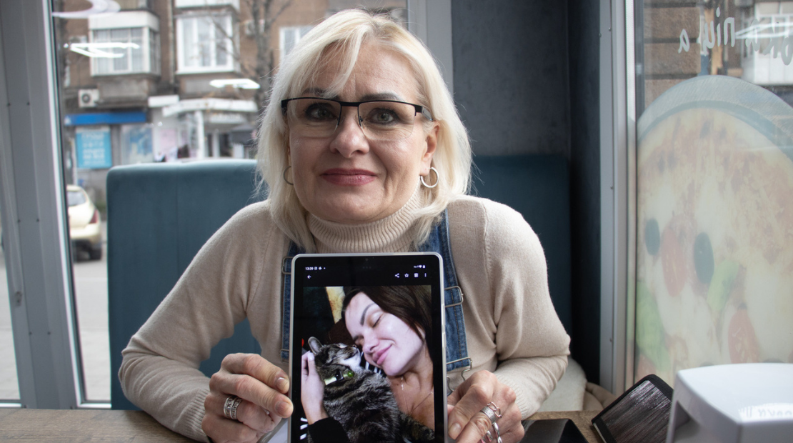 Elena, 53, and her daughter Yevgenia, 34, both survived bomb attack in eastern Ukraine. She is in a coffee shop showing a picture of her daughter and her cat. ; }}