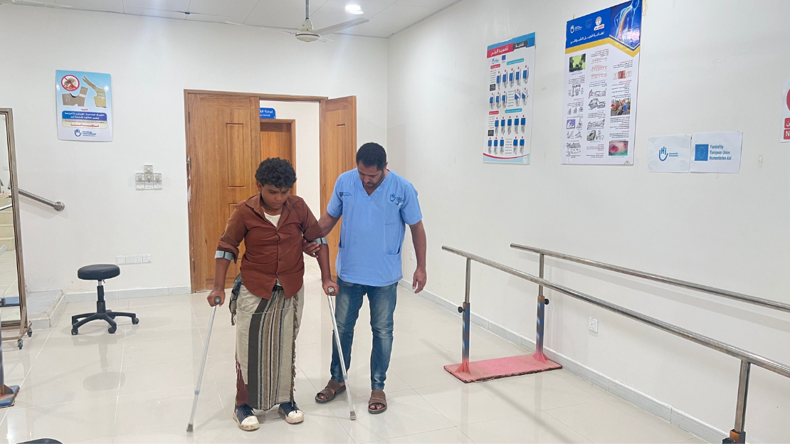 Hussein practicing walking with two prostheses 