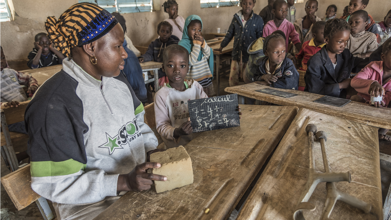 Samadou, 7, in class with a visiting Pedagogical Advisor, Burkina Faso; }}